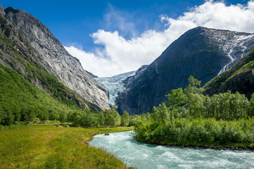 Fototapeta na wymiar Mountain river in Briksdalsbreen hike, Norway.