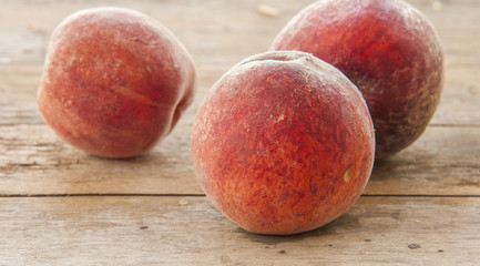 fresh peaches on wooden table