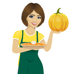 young beautiful woman holding freshly baked homemade pumpkin pie