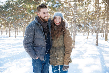 Fototapeta na wymiar Couple standing in winter park