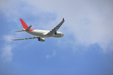 Fototapeta na wymiar side of commercial plane on blue sky