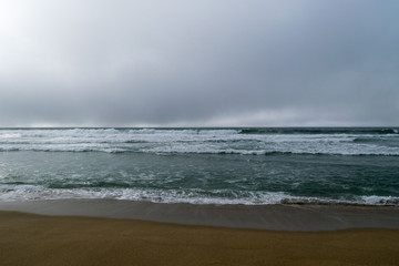 Misty day on Sandy beach near Monterey Bay, Central Pacific coast of California, USA