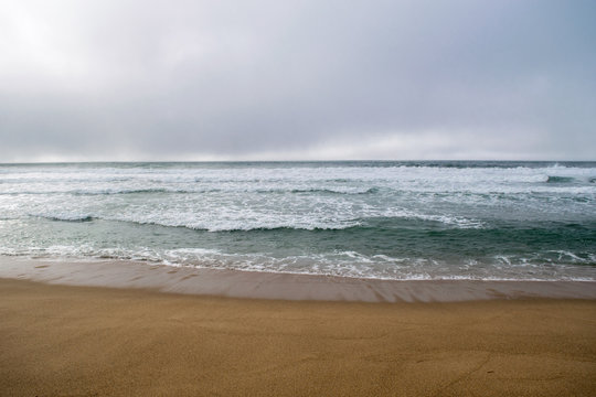 Misty day on Sandy beach near Monterey Bay, Central Pacific coast of California, USA