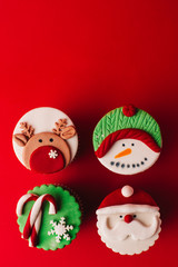 Christmas cupcakes on red background