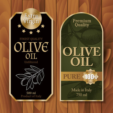 Vintage olive oil labels on wooden background 