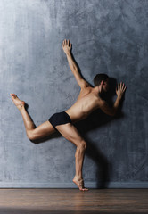 Naklejka na ściany i meble Graceful ballerina man in an art performance