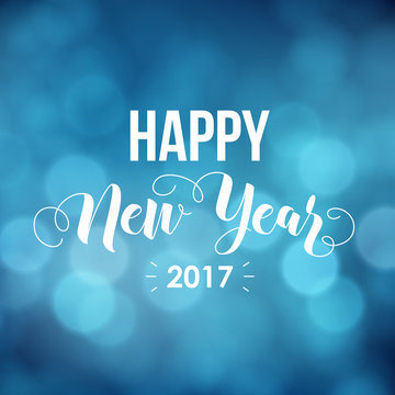 Happy New Year 2017 - greeting card. Modern calligraphy lettering. Typographic vector design, beautiful blue bokeh background, blurred festive lights.