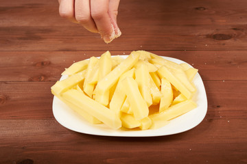 slicing raw potato on the plate