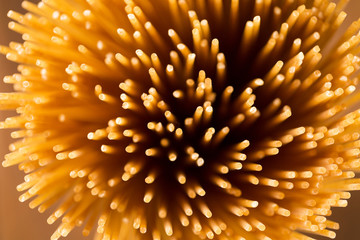 Obraz premium Yellow long spaghetti integral on a rustic background. Yellow it