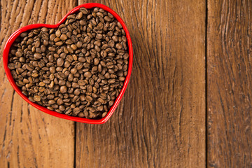 Coffee love concept. Coffee beans in heart into the bown