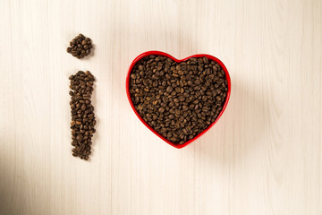 Coffee love concept. Coffee beans in heart into the bown