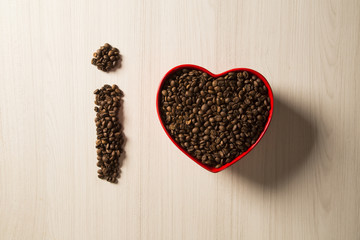 Coffee love concept. Coffee beans in heart into the bown