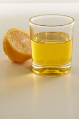 lemon and a glass of lemonade on a white background