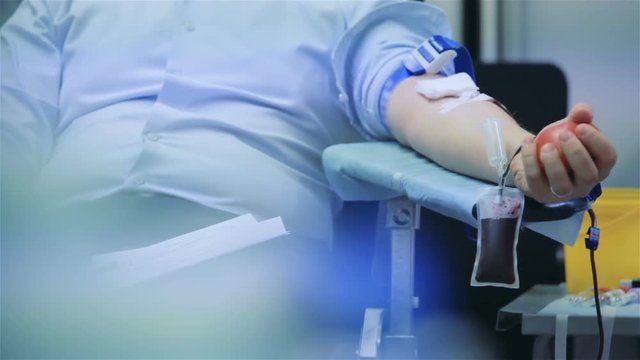 Male donor donates blood voluntarily in hospital