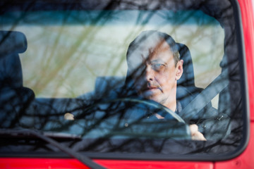 Obraz na płótnie Canvas man in his car behind wheel front view