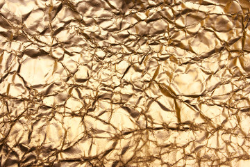 Golden background, shiny creased paper