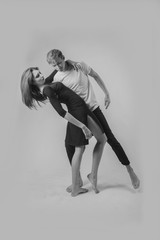couple dancing on a white background. A guy and a girl in dance movement black and white color