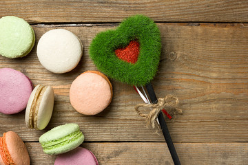 The concept of the celebration of love and attention, giving gifts. Sweet tooth dessert macaroon on wooden background with blank space. Valentine's day