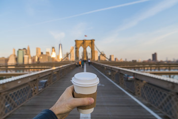 Hand holding coffee cup in New York City