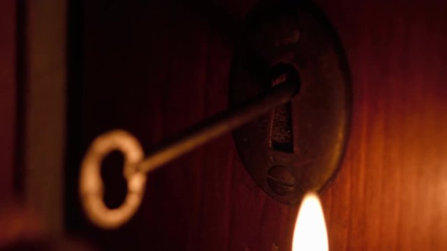 Skeleton Key Inserted In Door By Candlelight