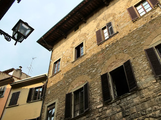The walls, windows and lamp of houses in  Florence