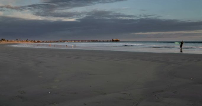 Panning time lapse near the jetty at Seal Beach, California. With dramatic clouds, fast moving waves, and off shore container ships
