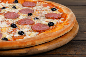 Delicious italian pizza served on wooden table