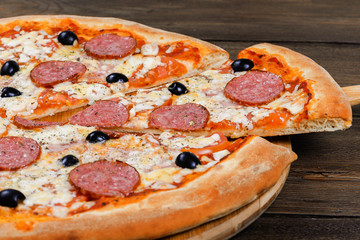 Delicious italian pizza served on wooden table