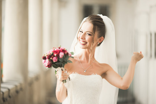 Luxury wedding bride, girl posing and smiling with bouquet