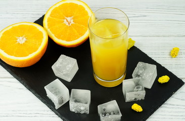 Orange juice with ice on black and white background 