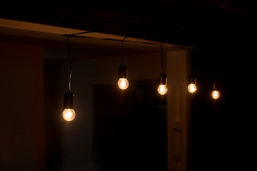 five included light bulbs in a dark room