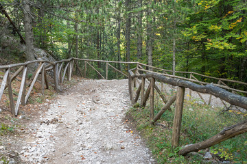 Stony descending footway with wooden rails on Mount Olympus track. Pieria, Greece.
