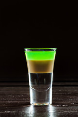 Colorful alcoholic cocktail in a shot glass