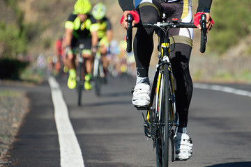Naklejka na ściany i meble Cycling competition,cyclist athletes riding a race at high speed