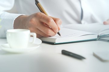 Man writing in organizer