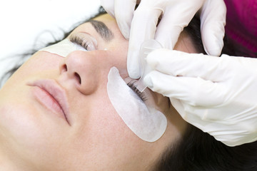 Woman on the procedure for eyelash extensions, eyelashes lamination