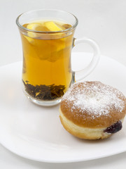 Transparent Cup with Tea and a Donut