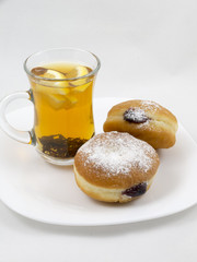 Transparent Cup with Tea and a Donut