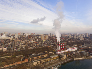 Modern aerial cityscape with a thermal power plant and river. Aerial view.