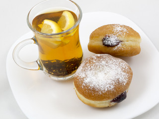 Transparent Cup with Tea and a Donut