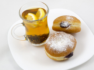Transparent Cup with Tea and a Donut
