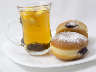 Transparent Cup with Tea and a Donut