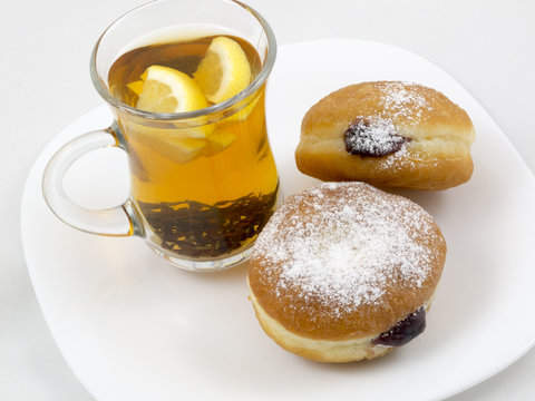 Transparent Cup With Tea And A Donut