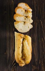 Top view of a sliced of baguette with herbs and spice