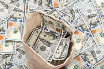 Open sack full of money dollars