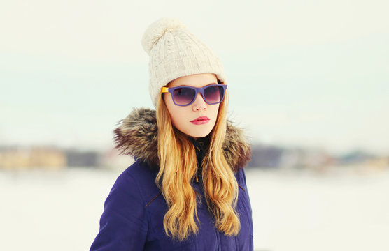 Fashion winter portrait blonde woman wearing jacket knitted hat