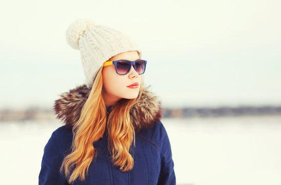 Fashion winter portrait pretty blonde woman wearing a jacket hat