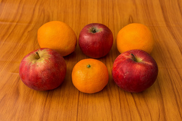 Apples and Oranges on brown background