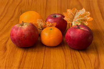 Fototapeta na wymiar Apples and Oranges on brown background