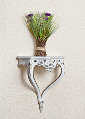 The console with a bouquet of dried flowers